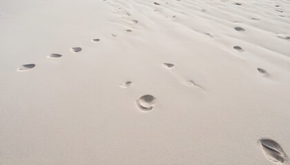 Fototapeta na wymiar Many foot prints on a white beach sand