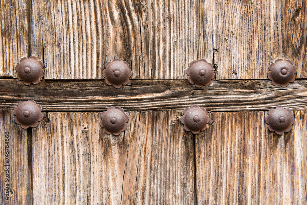 Wall mural Metal and wood details of an old door in a town in Spain