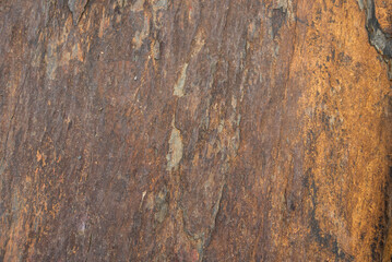 Detail of the texture of an old stone with metal veins and rust in an old town house.