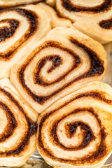 Freshly Baked Cinnamon Rolls Cooling on Stove Top