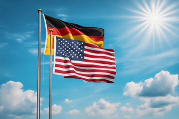 USA und BRD Flagge vor blauem Himmel im Wind als Hintergrund