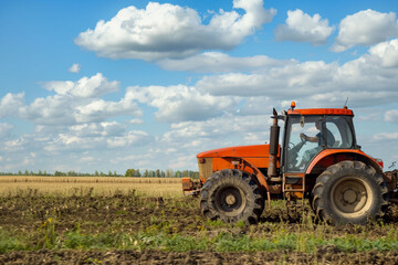 Fototapeta premium an agricultural tractor driving in the field