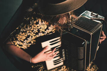 Woman playing the accordion. Close up. 