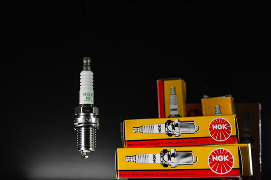Khmelnytskyi, Ukraine - February 10 2024: Spark plugs for NGK gasoline engines. A set of sparks with packaging on a black background. Auto parts sales concept. original box with spare parts