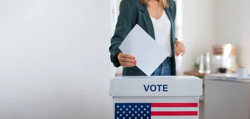 Foto op Canvas Unrecognizable woman putting her vote in the ballot box, usa elections. Banner with copy space. © Halfpoint