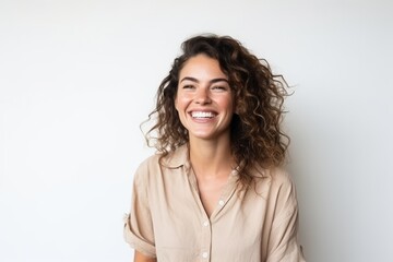Portrait of a beautiful young woman with curly hair smiling on white background