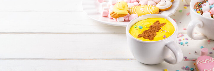 Hot sweet drinks for Easter party, breakfast, lunch. Easter menu. Pink, yellow, blue, brown multicolored hot chocolate cups with marshmallows, chocolate drawing rabbit, Easter eggs on latte surface