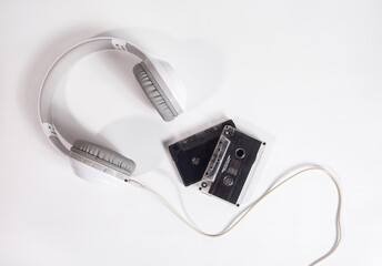 Headphones and vintage cassette isolated on white background. Flat lay view and concept.