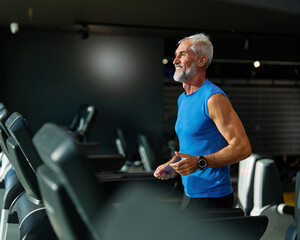 gym sport fitness exercising training mature man running cardio treadmill healthy active  adult mid...