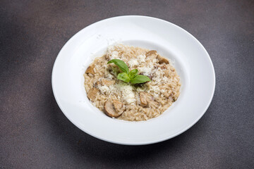Risotto with mushrooms and parmesan cheese in white plate