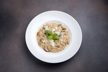Risotto with mushrooms and parmesan cheese in white plate
