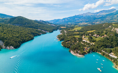 Aerial photo by drone of the Chanteloube bridge drowned in the turquoise waters of the Serre-Ponçon lake, located in the Hautes-Alpes, in France