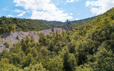 Fototapeta premium Aerial photography by drone of the rock formations, the Demoiselles Coiffées in Serre-Ponçon and its mountains, located in the Hautes-Alpes in France