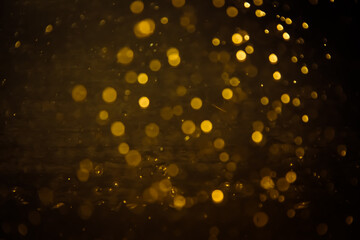 Blurred photo with golden dots visible glittering, shining brightly look and feel luxurious...
