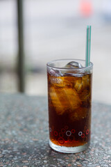 Cola with crushed ice and a straw in a clear glass is ready to drink to quench your thirsty