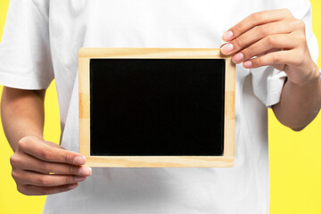 Woman holding frame with black blank space, mockup, place for text, copy space, advertisement