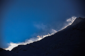 strong winds at the snowy mountain ridge above Saas-Fee