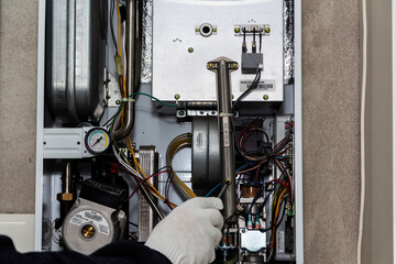 Heating Central Gas Furnace Issue. Technician Trying To Fix the Problem with the Residential Heating Equipment
