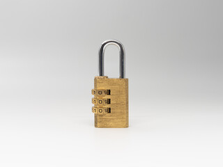 Combination lock isolated on white. Closed bracket of the golden metal object. Safeguard measure to...