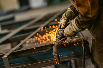 Factory worker grinding a metal,close up