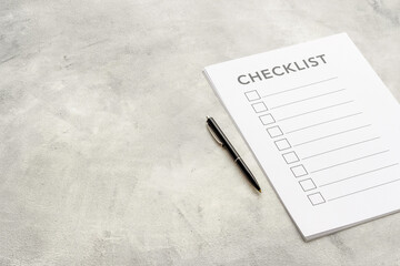 Checklist concept. Blank checklist with empty boxes on office table