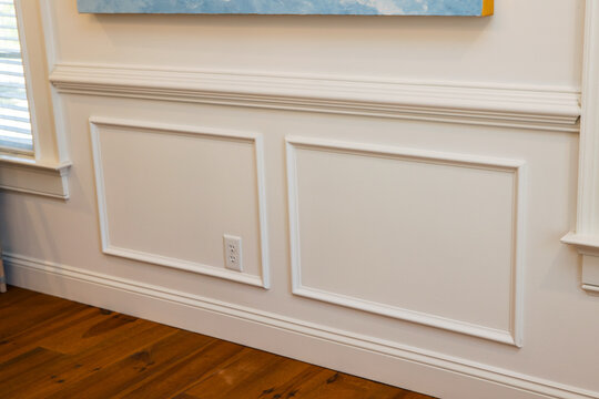Cream colored architrave decorative wall molding wall trim with skirting and panels in the interior of an old home house