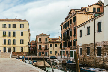 Fototapeta na wymiar Channel in Venice - boat and old town houses