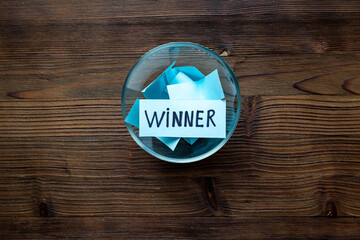 Winner concept. Lottery winner ticket in glass bowl full of paper sheets