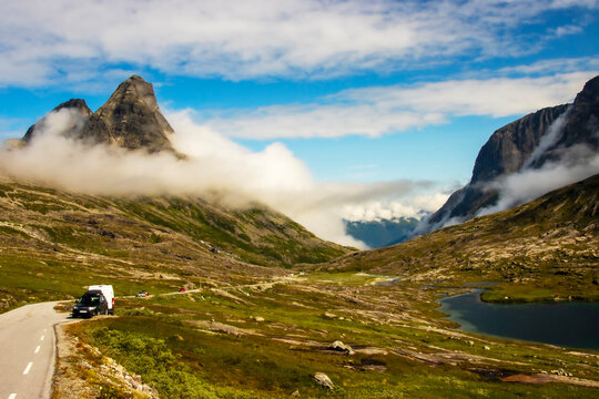 Vehicles in a layby in the valley overlooking Trollveggen Norway 