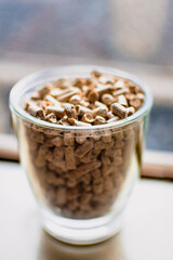 Pellet for stove or boiler in a glass, compressed wood granule