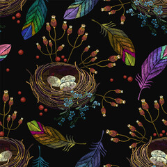 Colorful feathers and bird nest. Embroidery seamless pattern. Easter background. Template for clothes, t-shirt design
