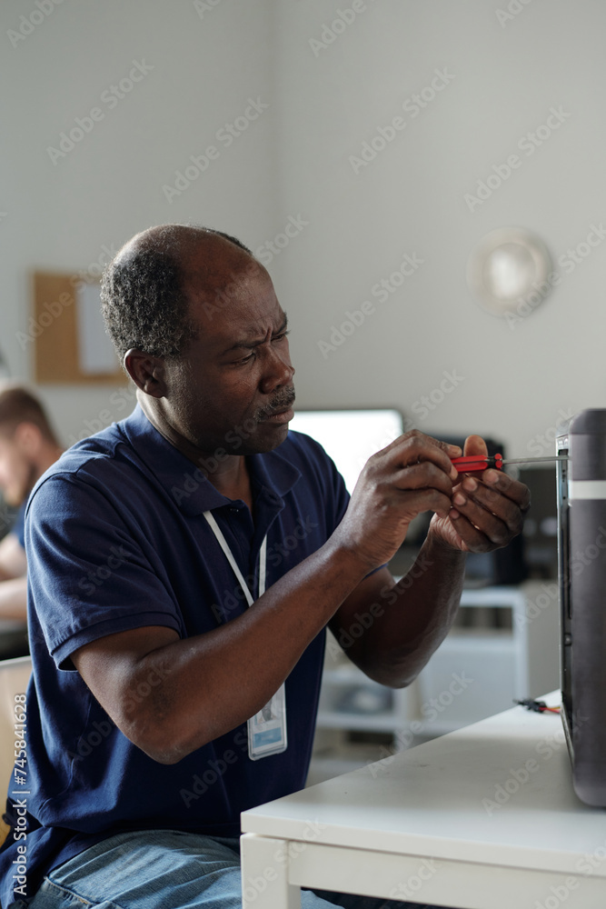 Poster mature african american specialist of technical repair center fixing parts of computer processor tog