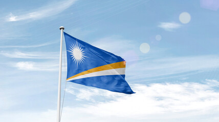 Marshall Islands national flag cloth fabric waving on the sky.