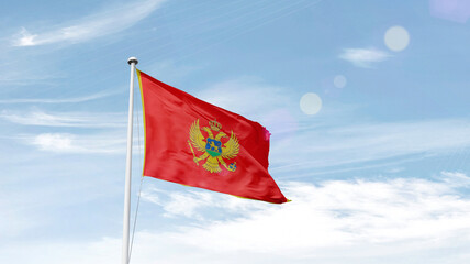 Montenegro national flag cloth fabric waving on the sky.