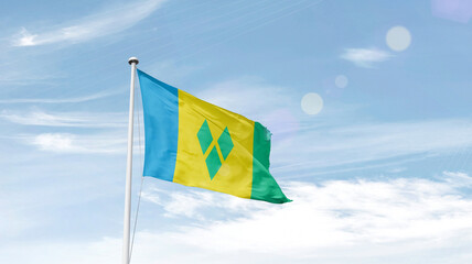 Saint Vincent and the Grenadines national flag cloth fabric waving on the sky. - obrazy, fototapety, plakaty