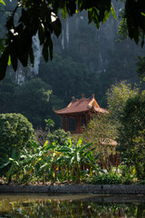 Temple roof of of Buddhist Đầm sen Bích Động with Mountain Background © Chris