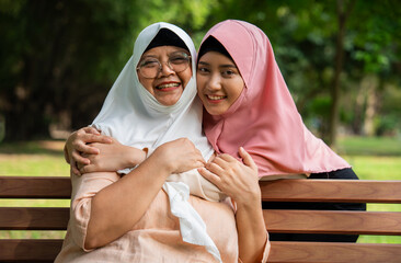 Muslim careful caregiver or nurse taking care of the patient in the hospital park. Happy Muslim...