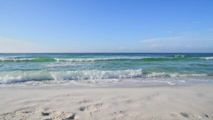 Emerald waters rolling up on pristine white sand beach in Florida