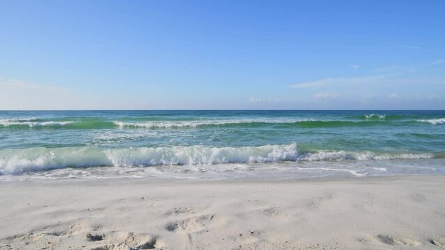 Emerald waters rolling up on pristine white sand beach in Florida