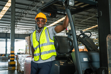 African forklift drivers focused on carefully transporting stock from shelves of a large warehouse...