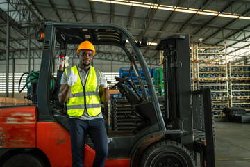 African forklift drivers focused on carefully transporting stock from shelves of a large warehouse...