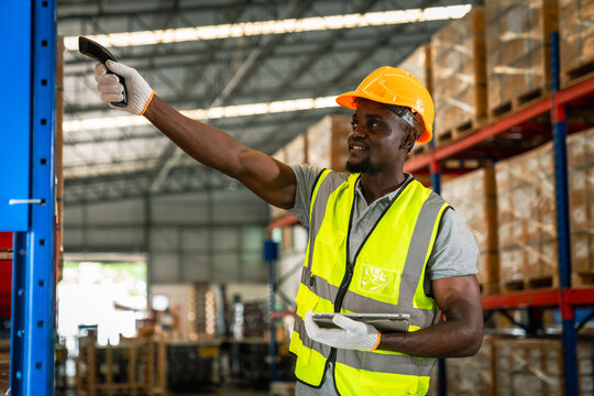 Picture of young man stock check and barcode scan in the warehouse. Holding a digital tablet in his hands.