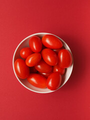Fresh organic cherry tomatoes in a white bowl