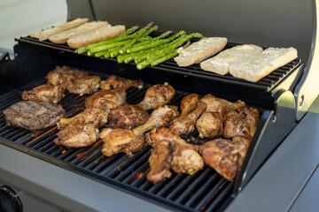 asparagus rib eye steak Bread and chicken cooking on a BBQ grill 