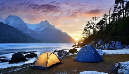 Camping on the lake beach in the forest, at the sunset.	
