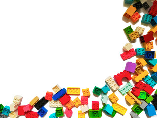 Multicolored blocks of the children's constructor lie on a white background