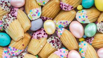 Many beautifully decorated Madeleines with sprinkles for Easter.