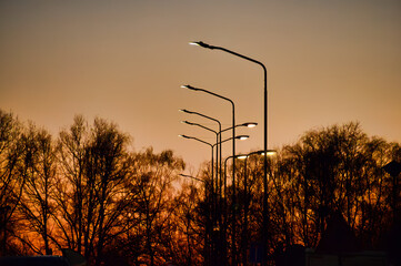 sunset in the countryside with street lanterns