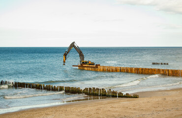 replacement with new breakwaters by the sea to protect the shore using a special machine