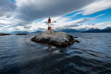 end of the world lighthouse in ushuaia argentina on an island of rocks in the beagle channel  
